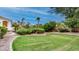 Lush backyard with well-maintained lawn, mature trees, and manicured landscaping at 11307 E Elmhurst Dr, Chandler, AZ 85249