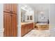 Elegant bathroom features custom cabinets, dual sinks, soaking tub, and a walk-in shower at 11307 E Elmhurst Dr, Chandler, AZ 85249