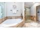 Luxurious bathroom with soaking tub and glass enclosed shower at 11307 E Elmhurst Dr, Chandler, AZ 85249