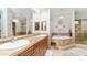 Elegant bathroom features a soaking tub, dual sinks, and custom cabinetry at 11307 E Elmhurst Dr, Chandler, AZ 85249