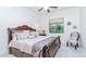 This is a bedroom featuring an elegant bed with a decorative headboard and plush pillows at 11307 E Elmhurst Dr, Chandler, AZ 85249