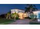 Stately entrance with a porte cochere, lush landscaping, and elegant lighting at 11307 E Elmhurst Dr, Chandler, AZ 85249