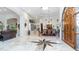 Spacious foyer featuring elegant marble flooring, custom wood door, and open layout, creating a grand entrance at 11307 E Elmhurst Dr, Chandler, AZ 85249
