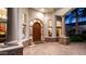 Grand entrance featuring custom wood door, decorative glass, and stone accents at 11307 E Elmhurst Dr, Chandler, AZ 85249