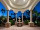 A stunning front entrance with pillars, a fountain, and manicured greenery at 11307 E Elmhurst Dr, Chandler, AZ 85249