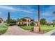 Beautiful home with lush green lawns, mature landscaping, and a circular driveway, showing luxury living at 11307 E Elmhurst Dr, Chandler, AZ 85249