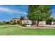 Elegant home featuring lush lawn, mature trees, and a circular driveway, creating inviting curb appeal at 11307 E Elmhurst Dr, Chandler, AZ 85249