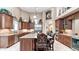 Elegant kitchen featuring an island with seating, stainless steel appliances, and custom cabinets at 11307 E Elmhurst Dr, Chandler, AZ 85249
