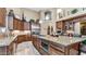Gourmet kitchen featuring an island with seating, stainless steel appliances, and custom cabinetry at 11307 E Elmhurst Dr, Chandler, AZ 85249