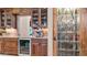 Gourmet kitchen features custom cabinetry, granite countertops, and a built-in beverage center at 11307 E Elmhurst Dr, Chandler, AZ 85249