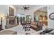 Inviting living room featuring a cozy fireplace, high ceilings and stylish furniture at 11307 E Elmhurst Dr, Chandler, AZ 85249