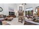 Spacious living room featuring a stone fireplace, plush seating, and ample natural light at 11307 E Elmhurst Dr, Chandler, AZ 85249