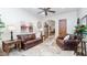Inviting living room with a leather couch, wooden side tables, and natural lighting from a nearby window at 11307 E Elmhurst Dr, Chandler, AZ 85249