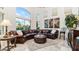 Living room with large windows, a leather sectional sofa, and elegant decor at 11307 E Elmhurst Dr, Chandler, AZ 85249