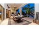 Outdoor dining area with a large wooden table, seating for eight, and a view of the pool area at 11307 E Elmhurst Dr, Chandler, AZ 85249
