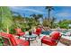 Outdoor patio area with comfortable seating and a view of the pool with rock waterfall at 11307 E Elmhurst Dr, Chandler, AZ 85249