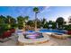 Backyard pool features a water slide, a hot tub, a fire pit, and a basketball hoop at 11307 E Elmhurst Dr, Chandler, AZ 85249