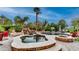 A beautiful backyard pool with a waterfall, spa, lush landscaping, and a basketball hoop at 11307 E Elmhurst Dr, Chandler, AZ 85249