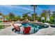 A resort-style pool with a waterfall, spa, lush landscaping, and plenty of space for outdoor seating at 11307 E Elmhurst Dr, Chandler, AZ 85249