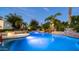Sparkling pool with beautiful rock waterfall and lush tropical landscaping at 11307 E Elmhurst Dr, Chandler, AZ 85249