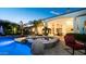 A backyard pool and spa is surrounded by lush landscaping, a covered patio, and lounge chairs at 11307 E Elmhurst Dr, Chandler, AZ 85249