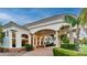 Elegant porte cochere featuring stone columns, arched entrances, and lush landscaping, providing a grand arrival at 11307 E Elmhurst Dr, Chandler, AZ 85249