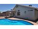 Inviting backyard featuring a sparkling pool and covered patio area at 11342 W Barbara Ave, Peoria, AZ 85345