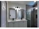 Modern bathroom featuring dual sinks, quartz countertop and glass-enclosed shower at 11342 W Barbara Ave, Peoria, AZ 85345