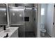 Modern bathroom featuring sleek vanity, a glass-enclosed shower and a toilet at 11342 W Barbara Ave, Peoria, AZ 85345