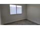 A cozy bedroom featuring gray wood-look floors and a window at 11342 W Barbara Ave, Peoria, AZ 85345