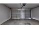 Spacious garage featuring a modern automatic door with interior lighting at 11342 W Barbara Ave, Peoria, AZ 85345