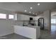 Modern kitchen with white cabinets, stainless steel appliances, and a breakfast bar at 11342 W Barbara Ave, Peoria, AZ 85345