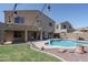 Great backyard featuring a gorgeous swimming pool, large patio area, and string lights at 11832 W Electra Ln, Sun City, AZ 85373