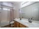 Bright bathroom featuring a double sink vanity, large mirror, and a tub with shower at 11832 W Electra Ln, Sun City, AZ 85373