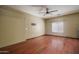 Empty bedroom with ceiling fan and wood flooring providing a blank canvas for personalization at 11832 W Electra Ln, Sun City, AZ 85373