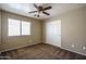 A cozy bedroom with brown carpet, a ceiling fan, and a window providing natural light at 11832 W Electra Ln, Sun City, AZ 85373