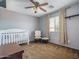 Neutral Bedroom with carpet, a ceiling fan, a crib, and a relaxing chair, creating a warm and inviting space at 11832 W Electra Ln, Sun City, AZ 85373