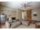 This is a large, open bedroom with a ceiling fan, a mini fridge, and access to a hallway at 11832 W Electra Ln, Sun City, AZ 85373