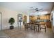 Dining room with modern table and chairs set, adjacent to the open kitchen space at 11832 W Electra Ln, Sun City, AZ 85373