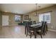 Inviting dining room area with elegant chandelier, large windows, and view of the living room at 11832 W Electra Ln, Sun City, AZ 85373