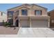 Two-story home with a tile roof, an American flag, and a two-car garage at 11832 W Electra Ln, Sun City, AZ 85373