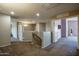 Upstairs hallway with neutral tones, carpet, and access to bedrooms and other rooms at 11832 W Electra Ln, Sun City, AZ 85373