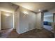 Open hallway featuring neutral paint, plush carpet and access to multiple rooms at 11832 W Electra Ln, Sun City, AZ 85373