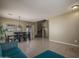 Spacious living area showing tile floors, dining set, and staircase at 11832 W Electra Ln, Sun City, AZ 85373