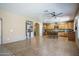 Open-concept living room with kitchen, dining area, and tile flooring at 11832 W Electra Ln, Sun City, AZ 85373