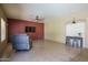 Relaxing living area with a recliner and TV for entertainment and leisure at 11832 W Electra Ln, Sun City, AZ 85373