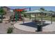 Community playground and covered picnic area with tables in a well-maintained park at 11832 W Electra Ln, Sun City, AZ 85373