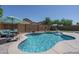 Beautiful backyard pool with a seating area under an umbrella, ideal for summer relaxation and entertaining at 11832 W Electra Ln, Sun City, AZ 85373