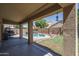 Inviting backyard showcasing a covered patio overlooking the sparkling pool and landscaped yard at 11832 W Electra Ln, Sun City, AZ 85373