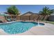 Inviting backyard pool features a built-in fountain and lush landscaping for a serene outdoor experience at 11832 W Electra Ln, Sun City, AZ 85373